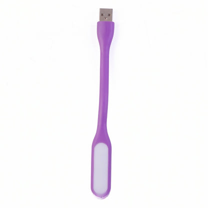Purple USB-powered LED light effectively illuminating a compact workspace.