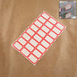 Sheet of red and white self-adhesive rectangular label stickers arranged neatly