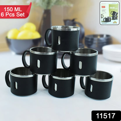 Close up of a stainless steel desk mug showing smooth polished surface and handle