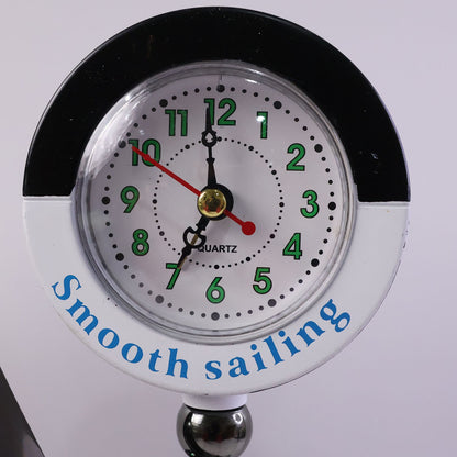 Ship shape clock lamp lit on table showing warm LED ambiance