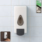 Sleek wall mounted soap dispenser in a modern bathroom setting.