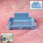 Plastic soap dish with drain slots and self-adhesive wall mount