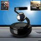 Solar-powered rotating car air freshener with galaxy design on dashboard