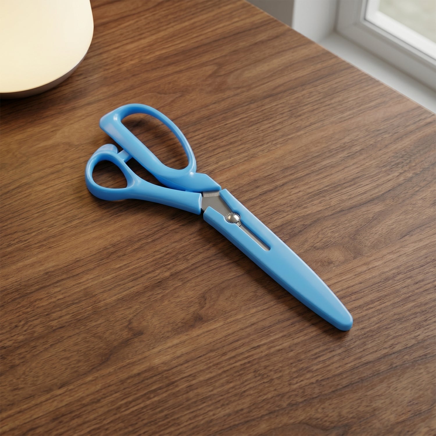 The stainless steel scissors in an open position, showcasing their wide cut.