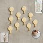 Set of 10 self adhesive round wall hooks arranged neatly for home organization