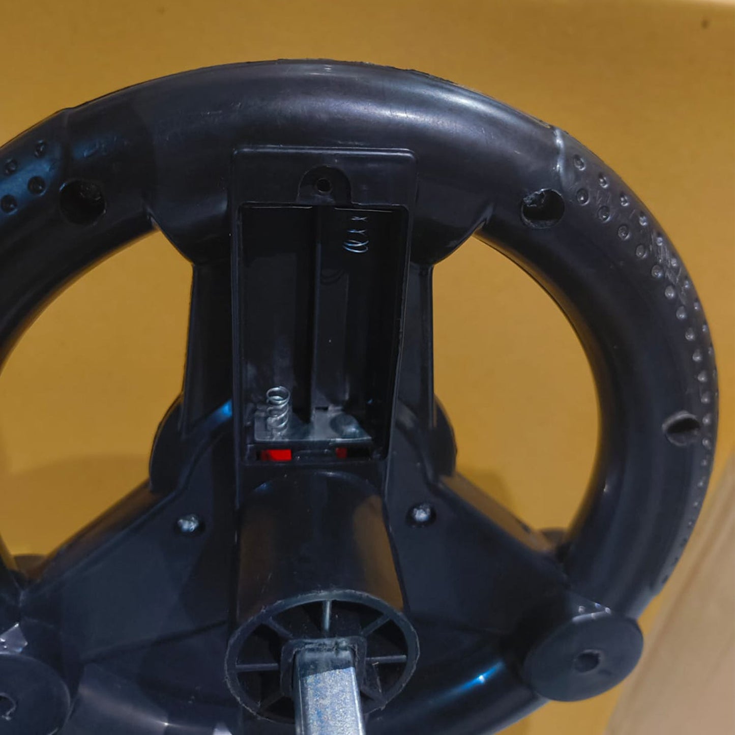 Front angle of toddler ride-on musical swing car toy for indoor use