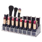 Clear acrylic lipstick holder with 24 sections, showcasing its organized cosmetic storage on a vanity.