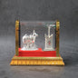 Silver-plated Kamdhenu cow idol set displayed in acrylic case with Tulsi plant