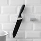 A sleek black punch-free wall hanging knife holder mounted on a kitchen wall, showcasing its modern design and space-saving functionality.