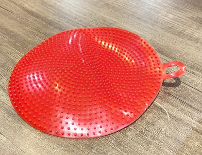 Close-up image of red silicone dish scrubbing sponge showing fine bristles