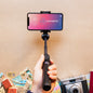 Compact Bluetooth selfie stick with phone tripod stand.
