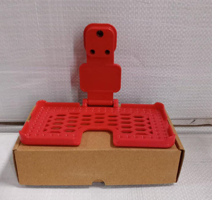 Lifestyle shot of the multi-purpose red wall holder, keeping cables tidy.