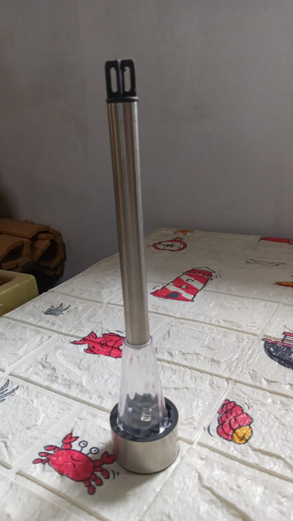 The solar LED spike light stands upright on a white patterned surface with red crabs and lighthouses.