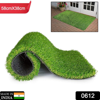 The durable plastic grass mat laid out, showcasing its vibrant green colour for a balcony.