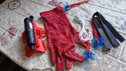 An action shot shows Web Shooter Toy projectiles successfully sticking to a wall.