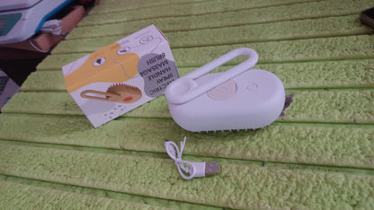 All components of the electric pet steam brush laid out for cleaning.
