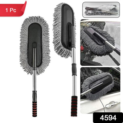 Hand using the soft Car Dust Brush to meticulously clean a car's dashboard without scratching surfaces.