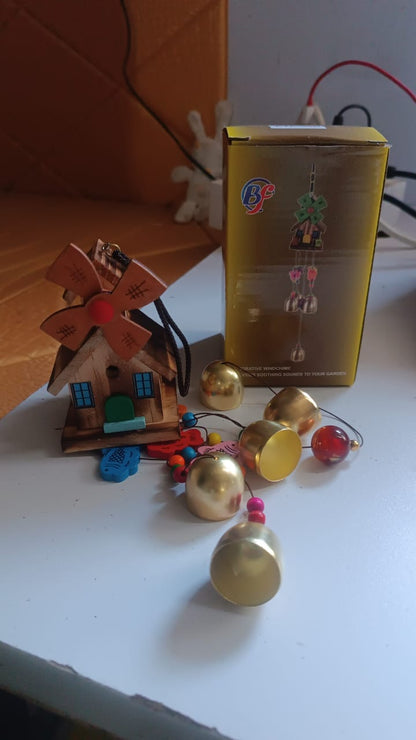 Peaceful garden setting with hanging dragonfly wind chime visible