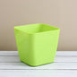 Vibrant square plastic flower pot for indoor or outdoor gardening.