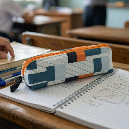 Open fabric pencil pouch with stationery accessories inside