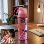 Pink sports water bottle with built-in mist spray front view