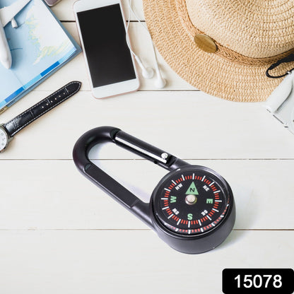 Close-up of the mini compass with clip, highlighting the clear dial and durable snap hook.